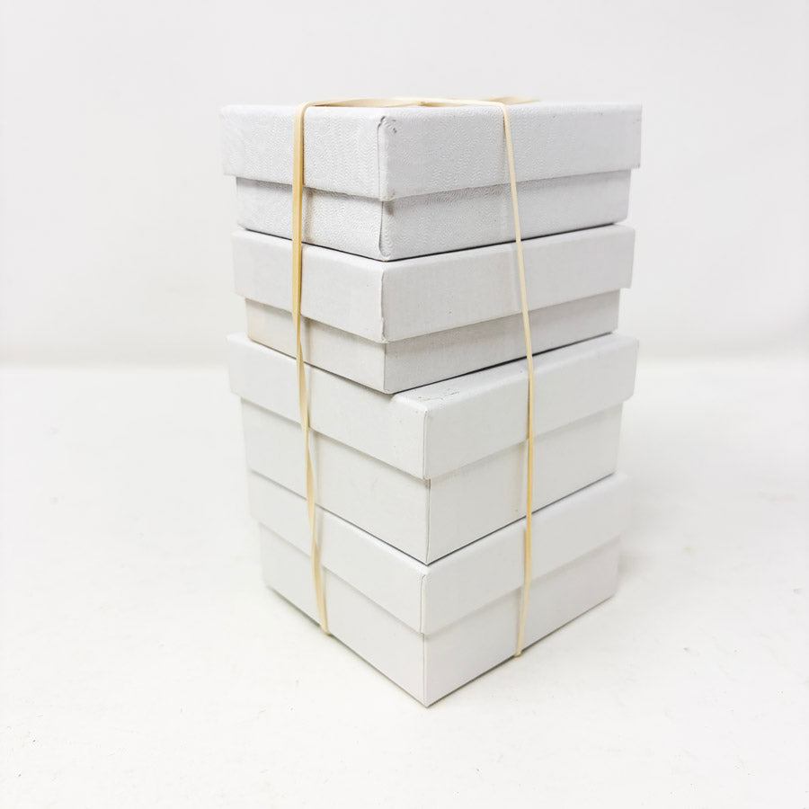Stack of White Paper Jewelry Boxes with Cotton Inserts