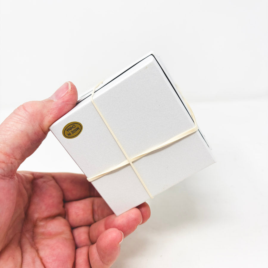 Stack of White Paper Jewelry Boxes with Cotton Inserts