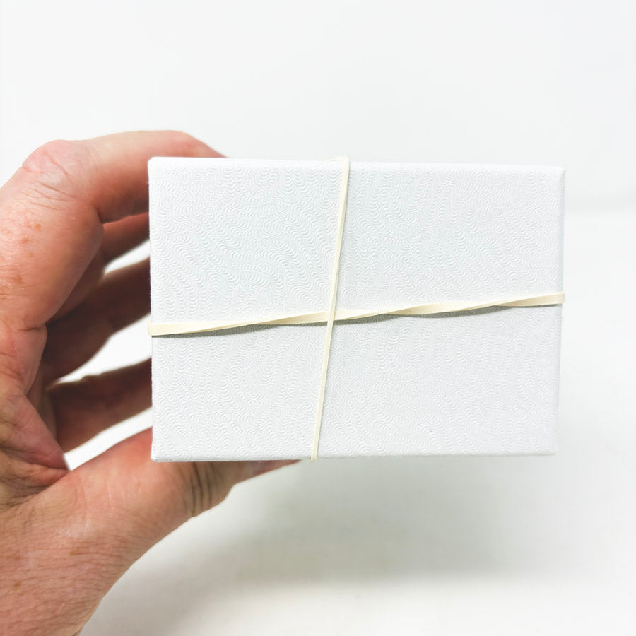Stack of White Paper Jewelry Boxes with Cotton Inserts