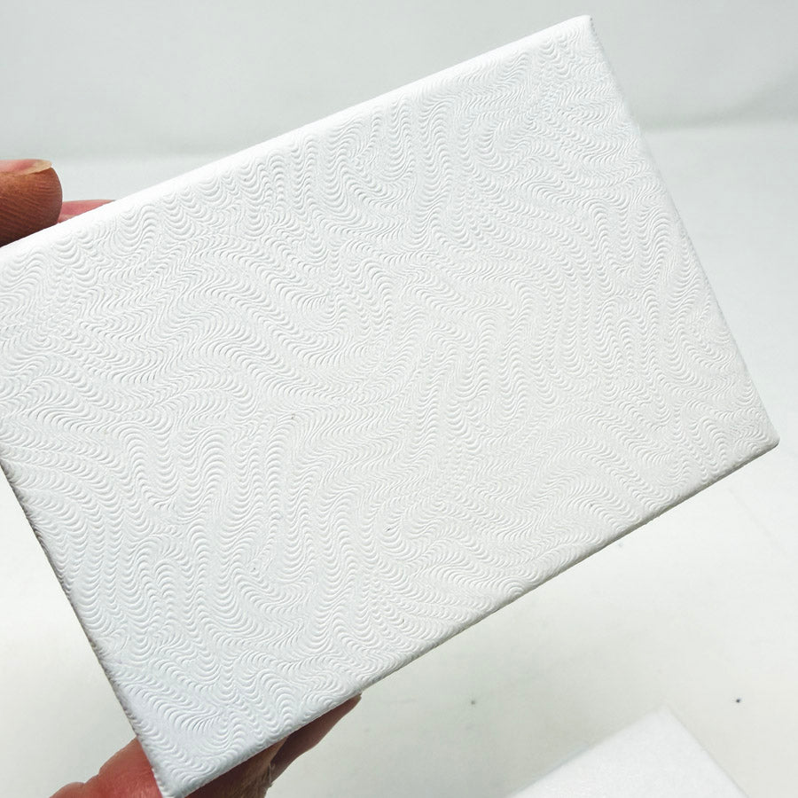 Stack of White Paper Jewelry Boxes with Cotton Inserts