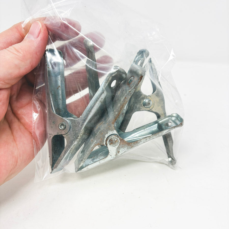 Four Small Metal Clamps