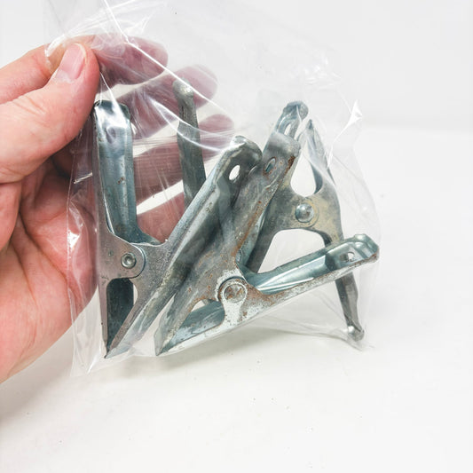 Four Small Metal Clamps