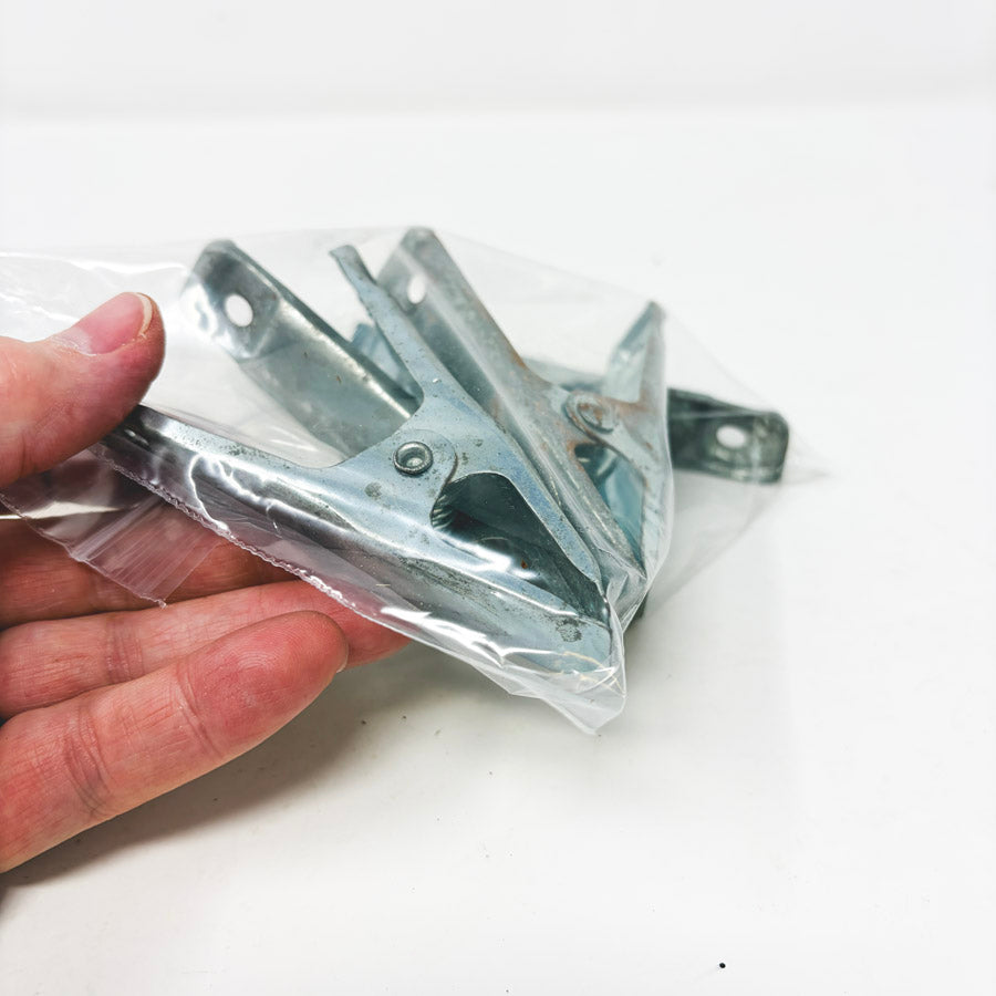 Four Small Metal Clamps