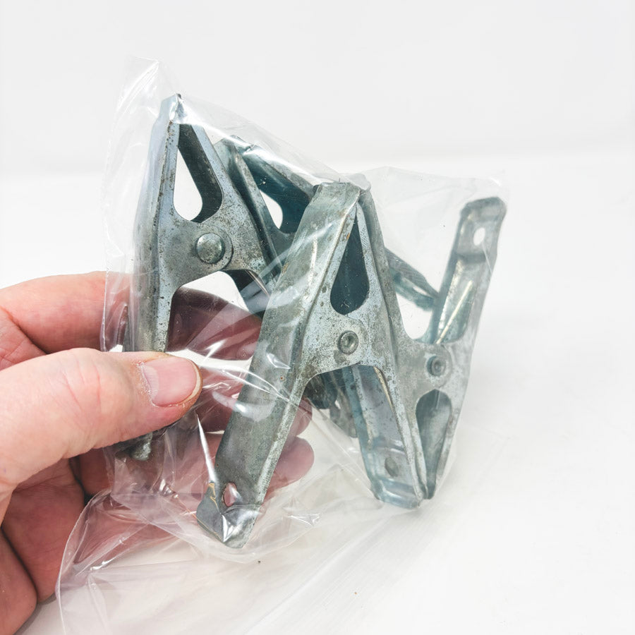 Four Small Metal Clamps