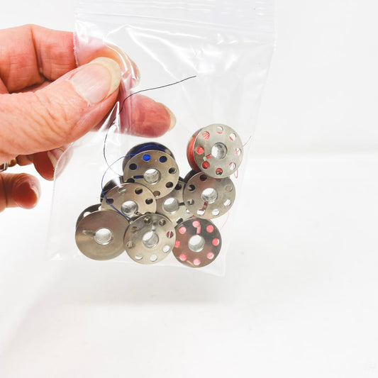 Eight Metal Bobbins