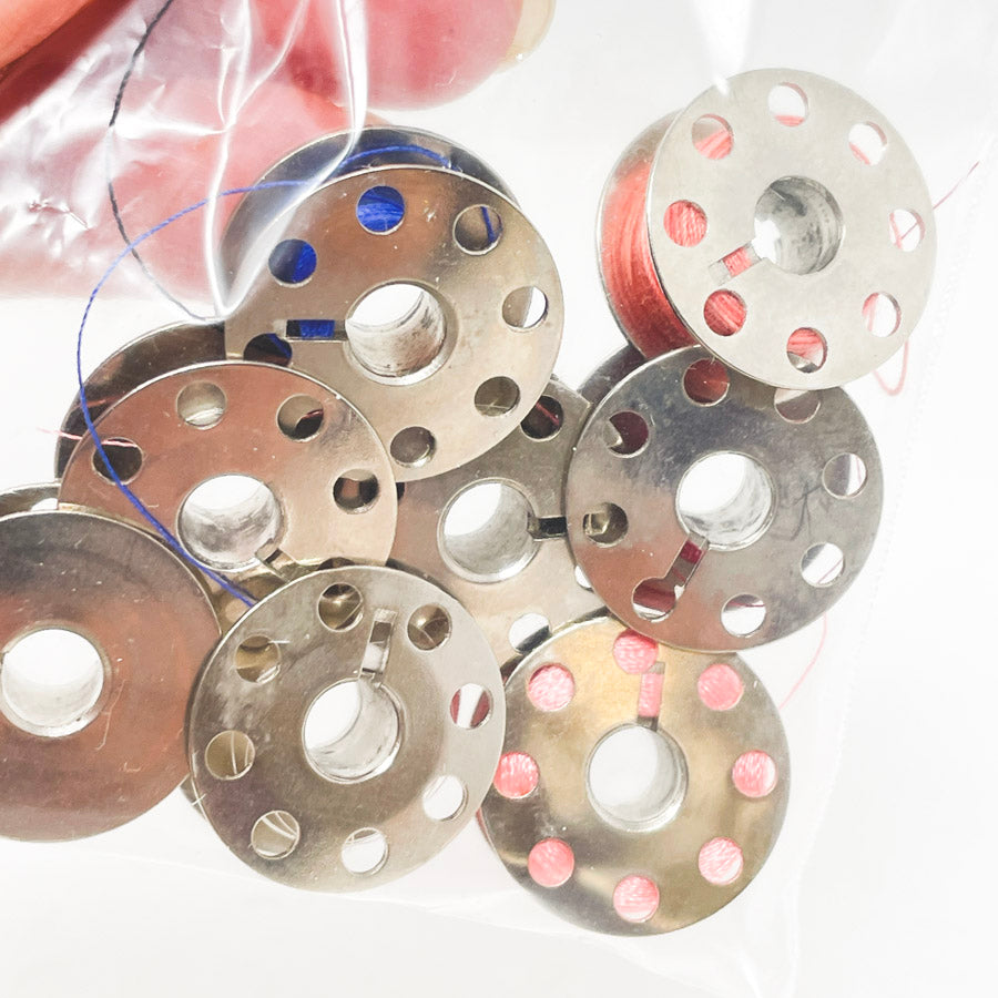 Eight Metal Bobbins