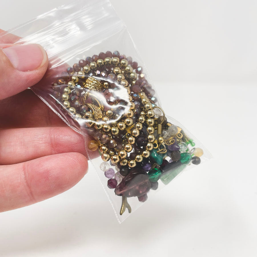 Purple, Green, and Gold Strung Beads and Jewelry