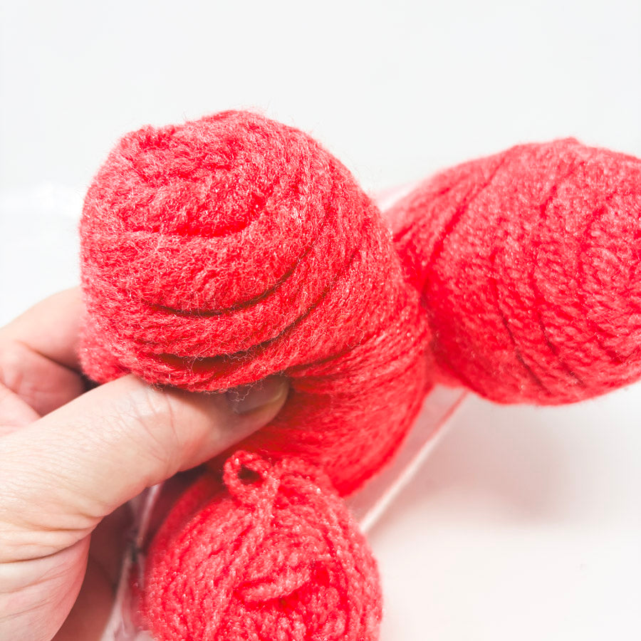 Bundle of Scratchy Bright Coral Yarn