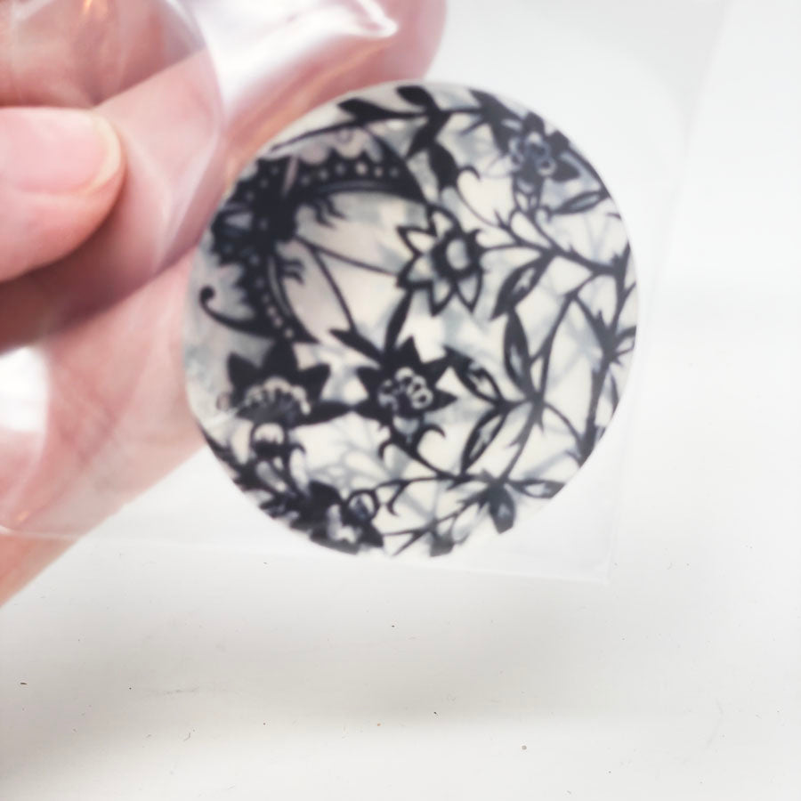 Plastic Disks with Black Flowers