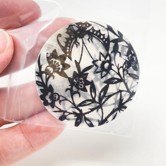 Plastic Disks with Black Flowers