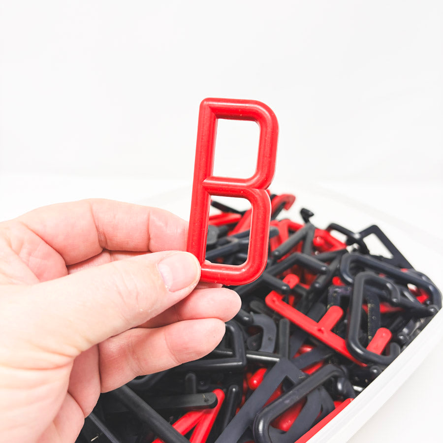 Box of Red and Black Felt Board Uppercase Letters